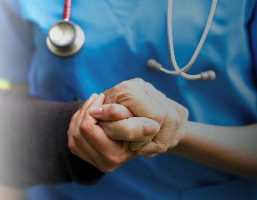 Family nurse practitioner holding hands with patient