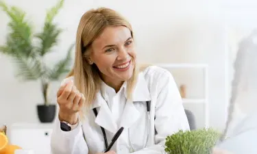 Pennsylvania family nurse practitioner smiling with pediatric patient during appointment